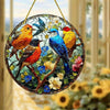 A circular acrylic hummingbird suncatcher featuring colorful birds perched on branches against a floral background.