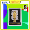 A display box featuring a gold-colored FIFA World Cup 2026 trophy figurine.