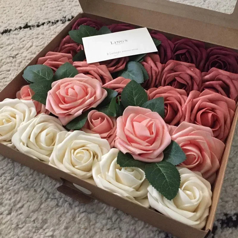 A box filled with lifelike foam roses in shades of pink and cream for wedding and home décor.