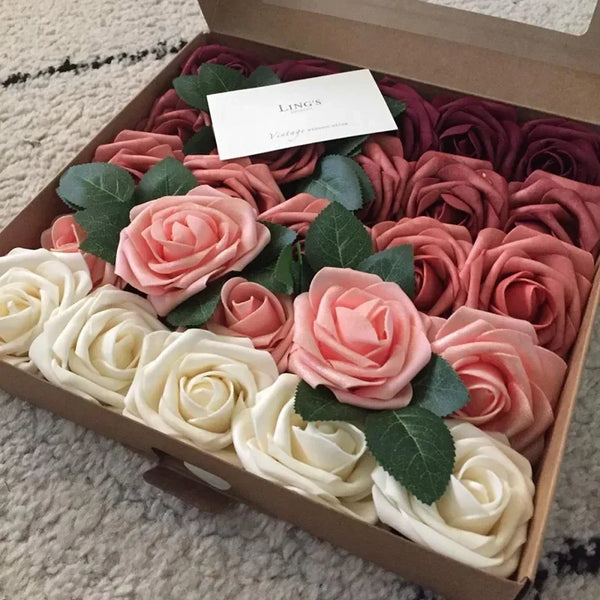 A box filled with lifelike foam roses in shades of pink and cream for wedding and home décor.