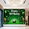 A green football themed birthday backdrop featuring a soccer ball, trophies, and crowns on a green field.