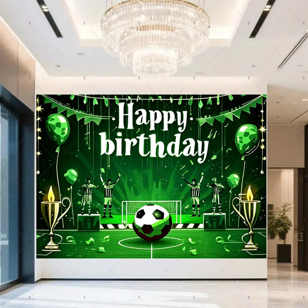 A green football themed birthday backdrop featuring a soccer ball, trophies, and crowns on a green field.