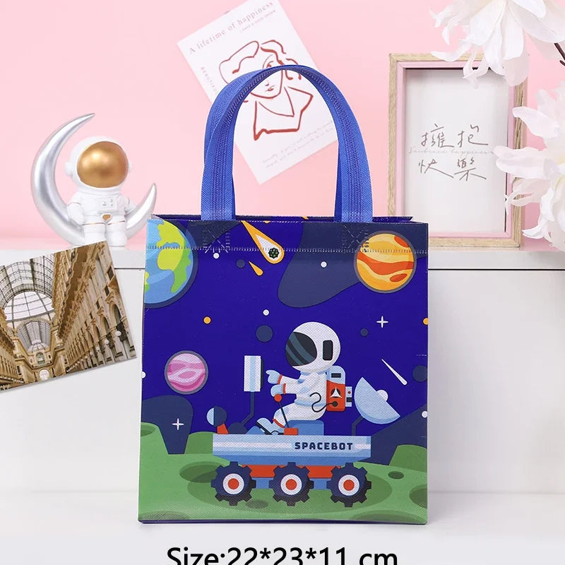 A dark blue tote bag featuring a space theme design with a white astronaut and rocket on the front.