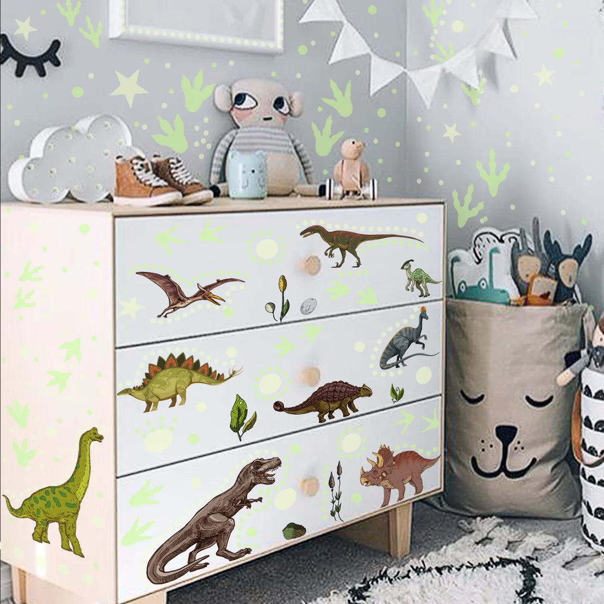 A shelf display of glow-in-the-dark dinosaur wall stickers featuring various dinosaurs and stuffed animals.
