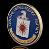Gold-plated CIA challenge coin featuring an eagle and stars, set in a protective case.