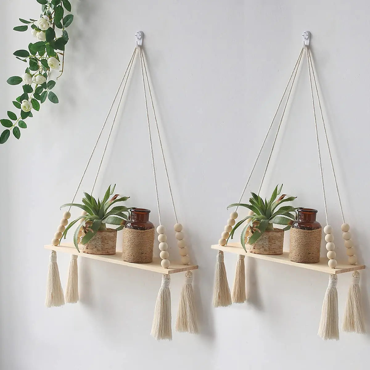 Macrame wood floating wall shelf with hanging rope displaying potted plants.