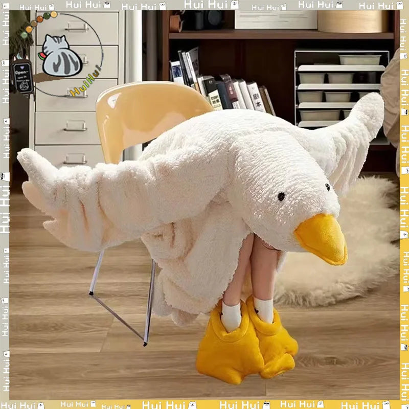 A white, fluffy cartoon goose lounge robe with yellow feet is displayed on a wooden floor.