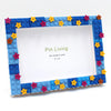 A DIY photo frame made of blue and purple blocks decorated with colorful star-shaped pins.