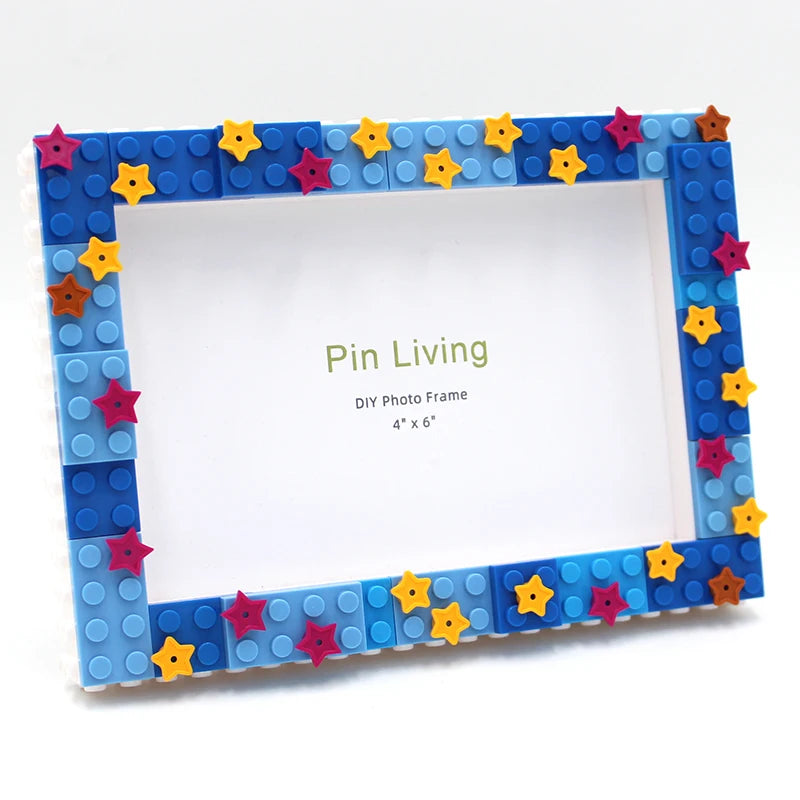 A DIY photo frame made of blue and purple blocks decorated with colorful star-shaped pins.