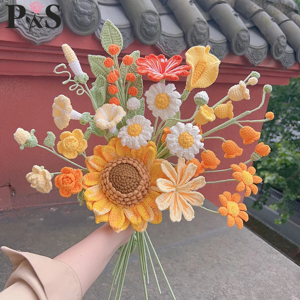 Un ramo de flores de ganchillo hechas a mano en tonos naranja, amarillo y blanco.
