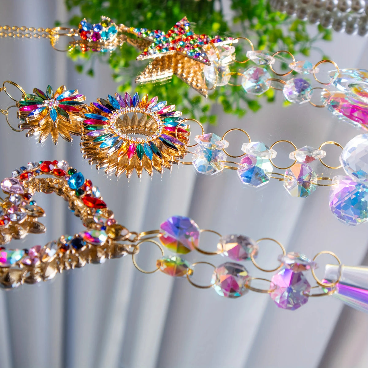 A close-up of a crystal rainbow maker sun catcher with love circle pentacle design featuring iridescent and clear crystals.