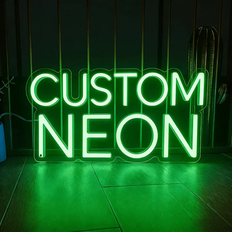 A glowing green neon sign spelling out CUSTOM NEON on a dark surface.