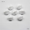 A collection of 19 white crystal ice cube acrylic stones for vase filler or decor.