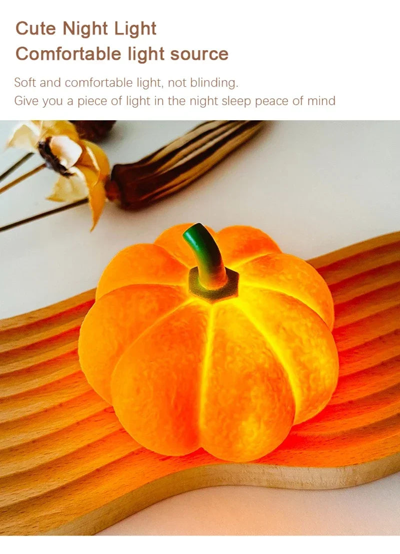 An orange decorative LED pumpkin night light resting on a wooden surface.