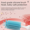 A close-up of a blue silicone brush head for baby bottle cleaning, shown next to a pink dish.