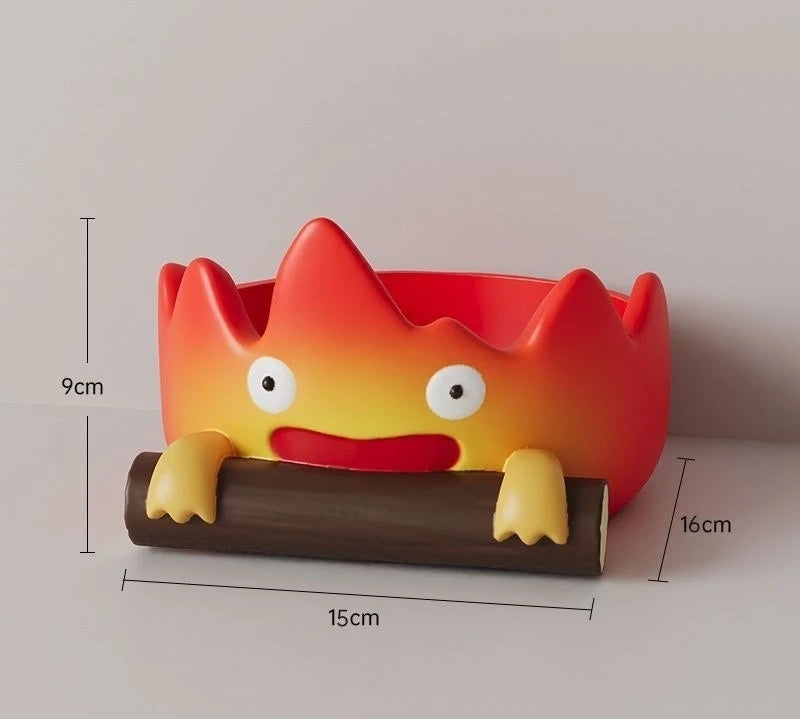 A resin key tray and desk organizer shaped like a cute, orange fire spirit with yellow accents.
