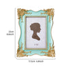 A light blue decorative photo frame with a gold-colored ornate border and a white mat, featuring a silhouette of a woman's pr
