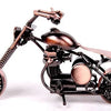 A handcrafted metal motorcycle model with a dark finish and vintage details.