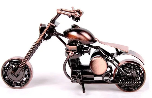 A handcrafted metal motorcycle model with a dark finish and vintage details.