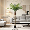 A tall artificial golden palm tree in a black pot displayed in a modern living room setting.