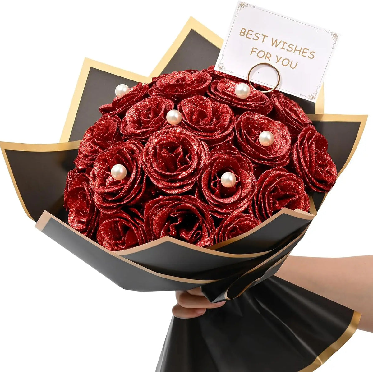 A bouquet of deep red glitter roses with white pearl accents presented in a black paper holder.