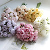 A bouquet of artificial pink peony silk flowers in various shades of pink and cream.