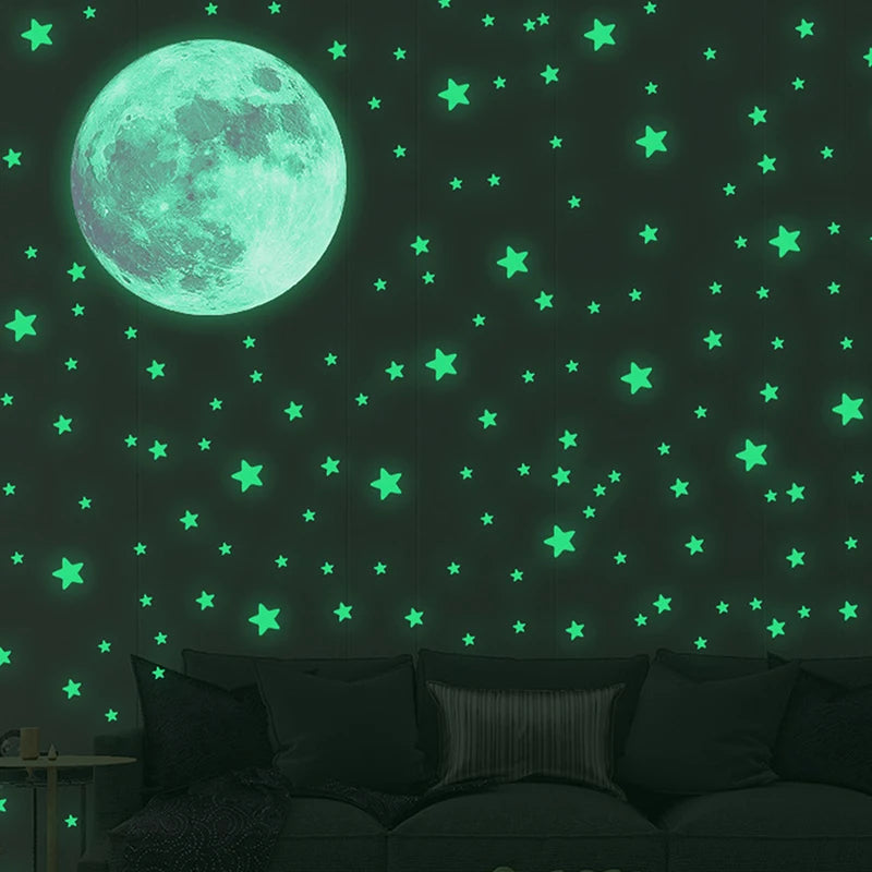 A dark green wall decorated with glowing teal stars and a large, bright cyan moon.