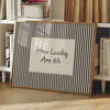 A framed canvas print with black and white vertical stripes featuring the text How Lucky Are We