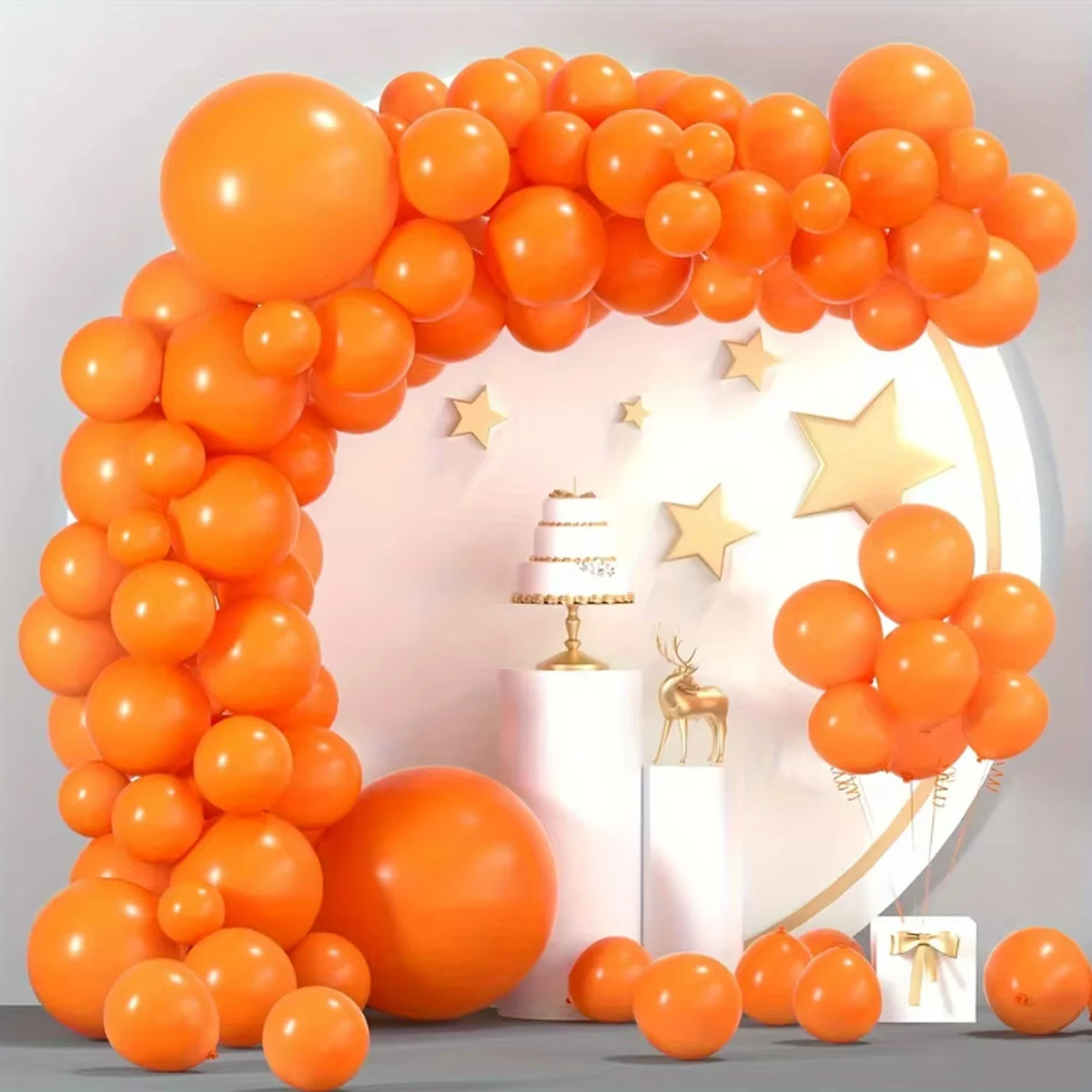 A large archway made of orange latex balloons decorated with gold stars and a single orange balloon.