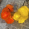 A close-up of bright yellow LED marigold string lights resting on a page of printed text.