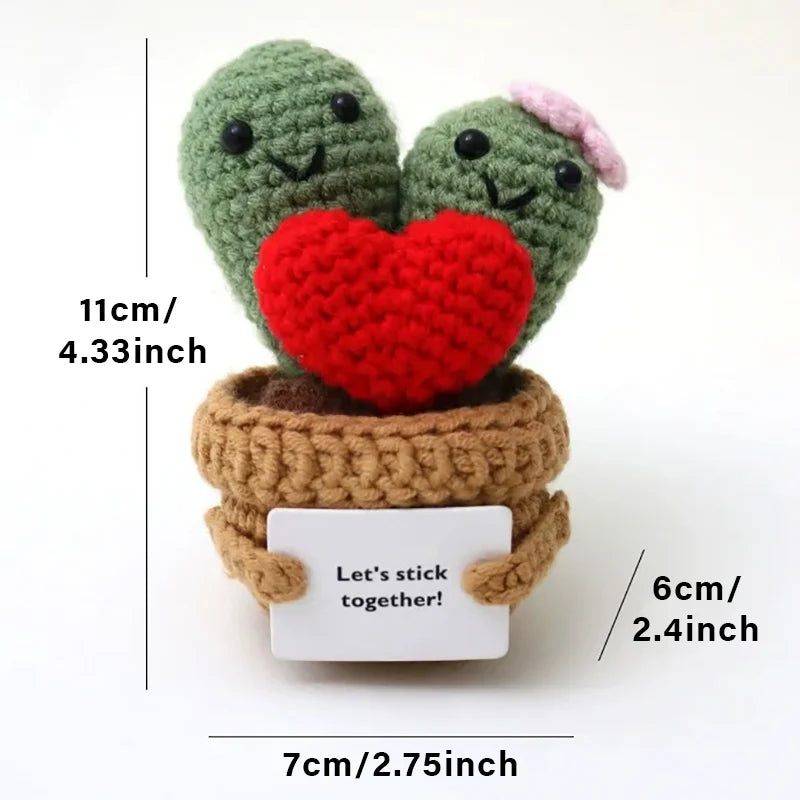 Handmade crochet potato dolls with hearts and a card displayed on a white background.