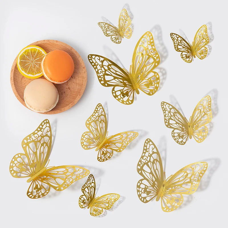 A collection of decorative gold-colored 3D butterfly wall stickers and natural fruit slices on a wooden surface.