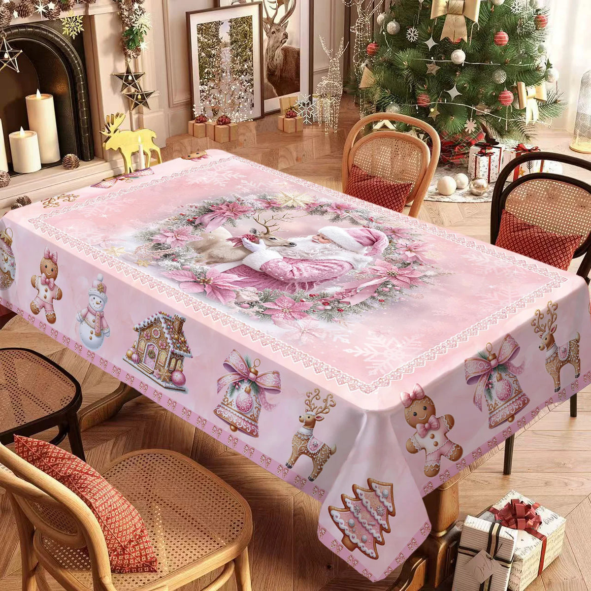 Pink Christmas poinsettia rectangle tablecloth displayed on a wooden table near a decorated Christmas tree.