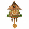 A vintage wooden cuckoo clock featuring a detailed facade and a hanging maple leaf base.