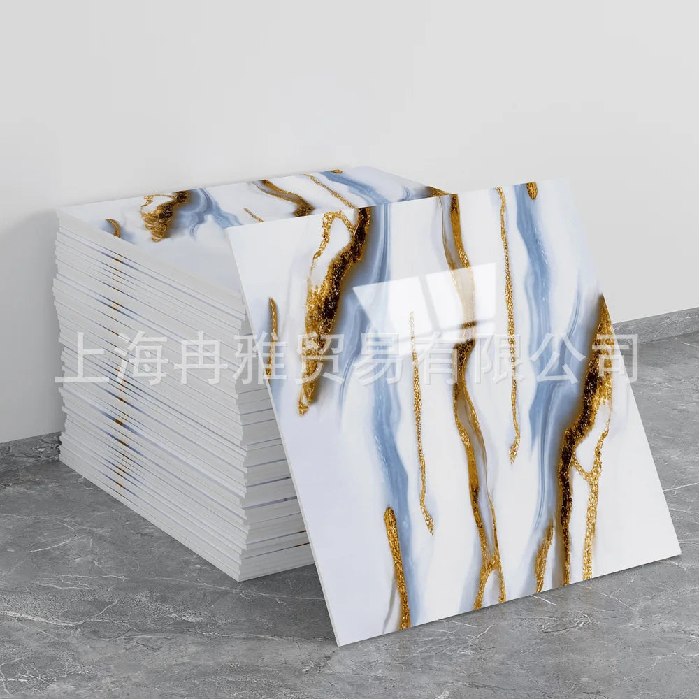 Stack of faux marble 3D self-adhesive wall tiles featuring blue and gold veining