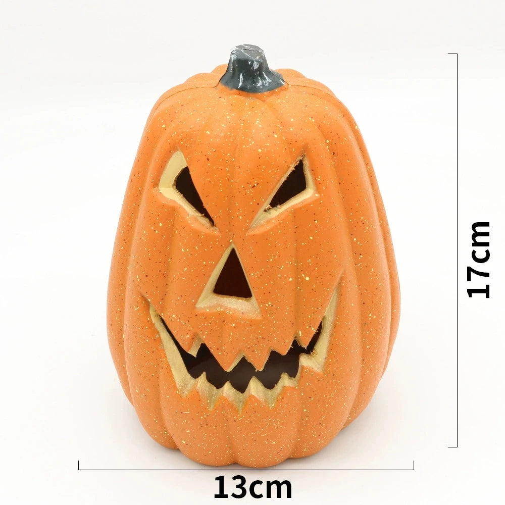 An orange carved pumpkin decoration with a menacing face and glowing features.