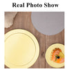 A round yellow cardboard cake board with a circular cutout for dessert display on a wooden surface.