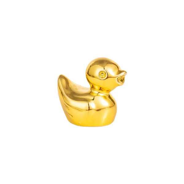 A miniature golden duck figurine.