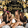 Five young women smiling and celebrating in front of a black and gold birthday party backdrop with balloons and confetti.