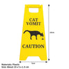 Yellow plastic yard sign with black silhouette of a cat and text warning about cat vomit.