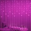 Pink curtain illuminated by strings of LED butterfly lights
