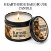 A jar of Hearthside Bakehouse candle in a black tin with a gold label and gift box