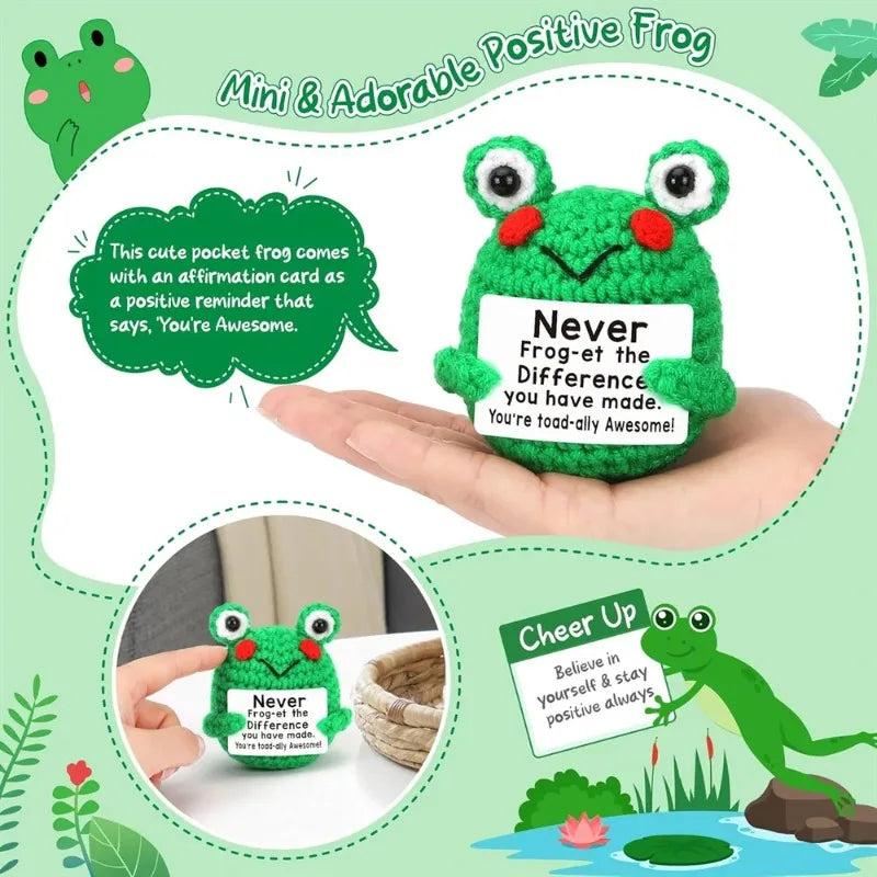 A hand holds a green crochet frog ornament with a tag that reads Never Frog-et the Difference You have made.