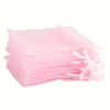 A stack of elegant white and gold drawstring organza bags for gifts, weddings, and parties.