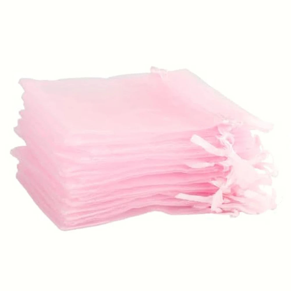 A stack of elegant white and gold drawstring organza bags for gifts, weddings, and parties.