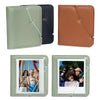 A set of five brown and green PU leather photo albums with a zipper closure and a larger album containing instant camera prin