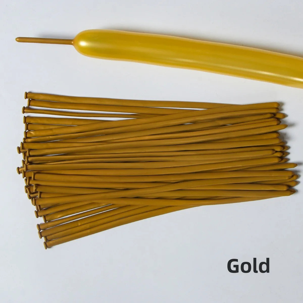 A collection of gold latex strip balloons and a yellow balloon are displayed on a white background.