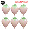Six pink strawberry foil balloons with green leaves and white flowers for party decorations