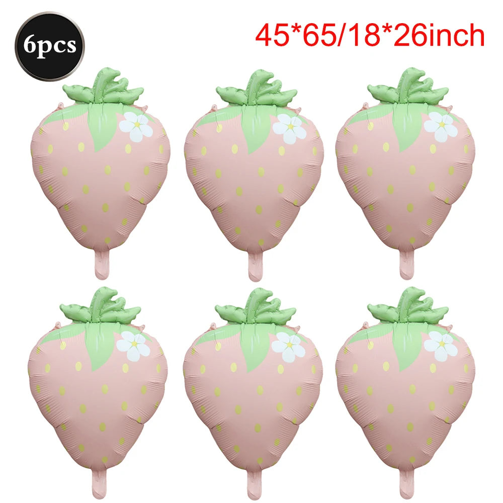 Six pink strawberry foil balloons with green leaves and white flowers for party decorations