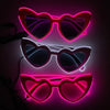 Three pairs of heart-shaped LED wire party glasses glowing in pink and purple light.
